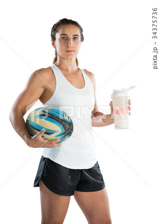 Portrait of female rugby player with ball and drinking bottle 34375736