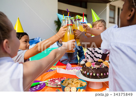 Children toasting juice 34375849