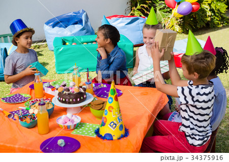 Happy children at birthday party Happy children at birthday party 34375916