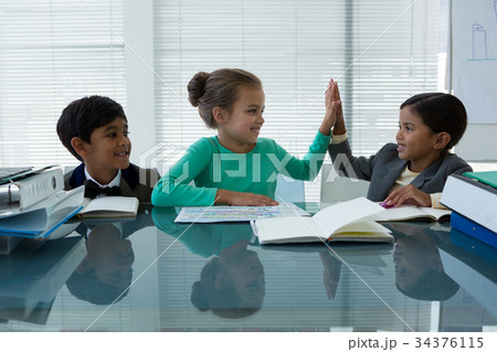 Happy business people working in boardroom 34376115