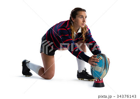 Full length of young female athlete keeping rugby ball on tee 34376143