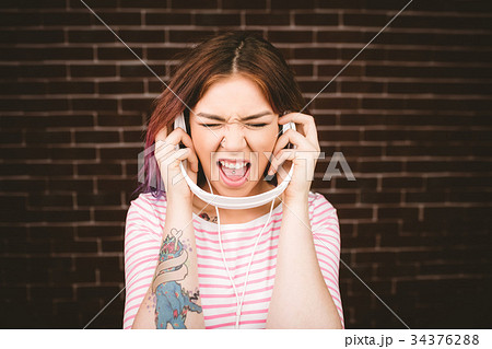 Woman listening music on headphones 34376288
