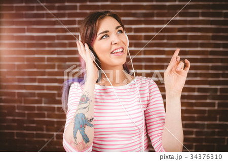Woman listening music on headphones 34376310