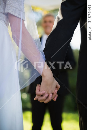 Mid section of couple holding hands Mid section of couple holding hands 34376441