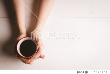Womans hand holding coffee cup 34376473