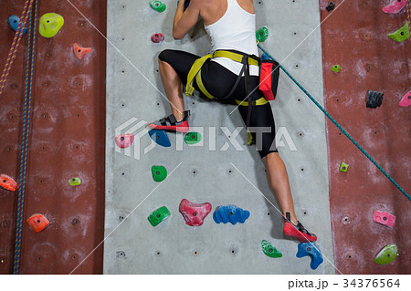 Woman practicing rock climbing in fitness studio 34376564