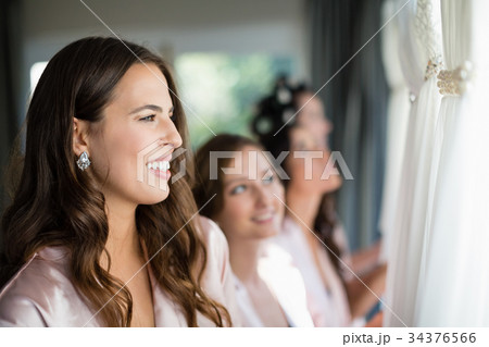 Smiling women looking at wedding dress 34376566