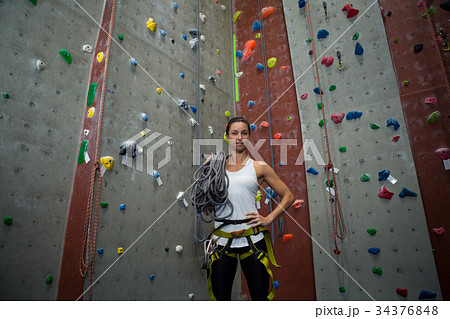 Woman standing with hands on hip in fitness studio 34376848