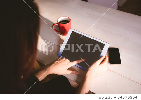 Attentive executive using digital tablet 34376904