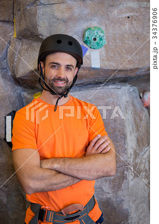 Trainer standing with arms crossed in fitness studio 34376906