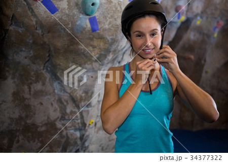 Woman wearing protective helmet in fitness studio Woman wearing protective helmet in fitness studio 34377322