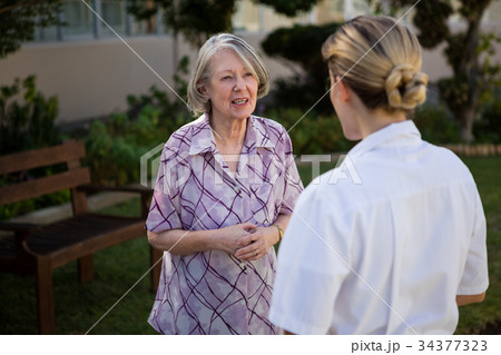 Senior woman and doctor talking in park 34377323
