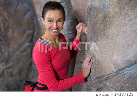 Portrait of confident woman practicing rock climbing Portrait of confident woman practicing rock climbing 34377329