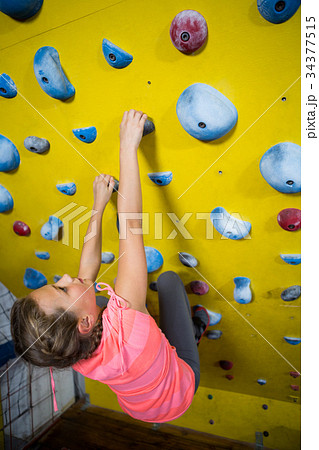 Teenage girl practicing rock climbing 34377515