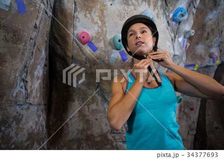 Woman wearing protective helmet in fitness studio Woman wearing protective helmet in fitness studio 34377693