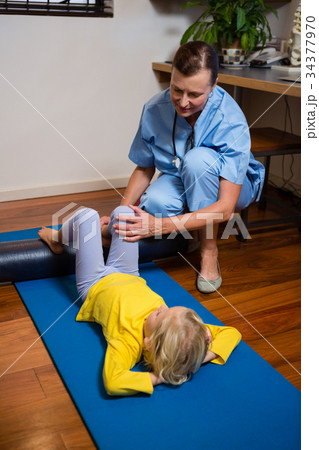 Physiotherapist giving physical therapy to the girl Physiotherapist giving physical therapy to the girl 34377970
