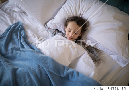 Girl sleeping on bed in bedroom Girl sleeping on bed in bedroom 34378156