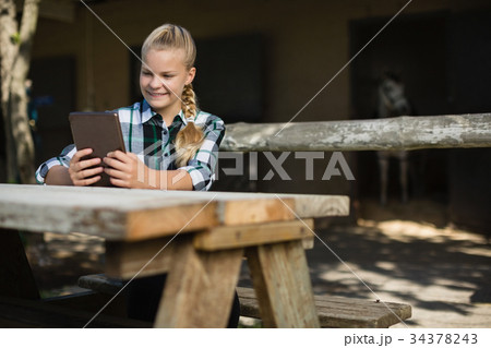 Girl using digital tablet Girl using digital tablet 34378243