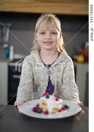Little girl posing with a fruit pancake Little girl posing with a fruit pancake 34378888