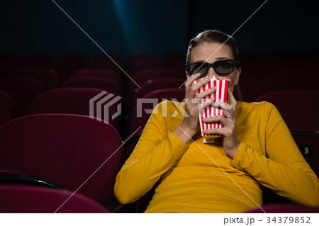 Woman scared while watching movie 34379852