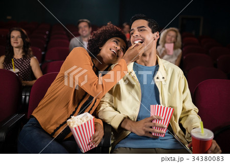 Couple watching movie in theatre Couple watching movie in theatre 34380083