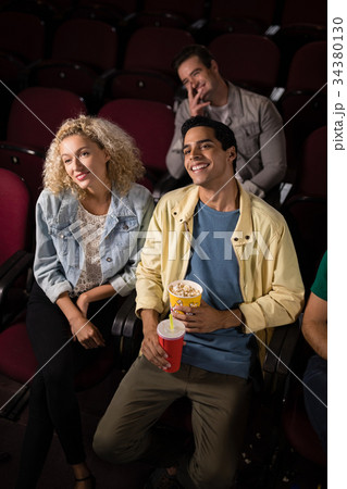 Couple watching movie in theatre 34380130