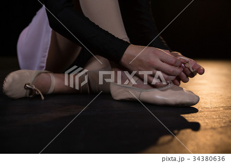 Ballerina tying her shoes 34380636