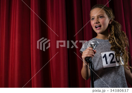 Female artist singing song on stage 34380637