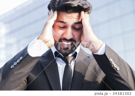 Angry businessman or worker with hands on head Angry businessman or worker with hands on head 34381302