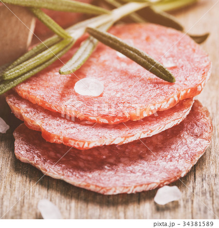 italian salami sausage slices with rosemary and 34381589