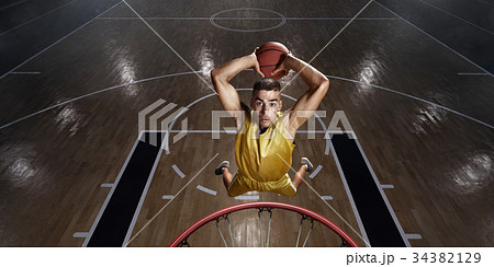 Basketball player makes slam dunk 34382129