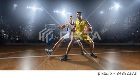 Basketball players on big professional arena 34382272