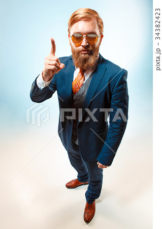 Portrait of a business man isolated on blue 34382423