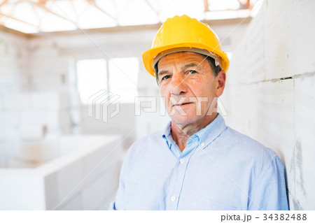 Senior architect or civil engineer on the 34382488