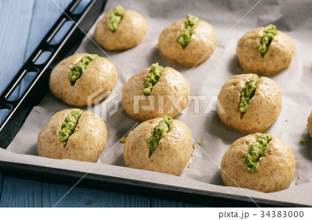 Homemade garlic bread rolls on wooden background.  34383000