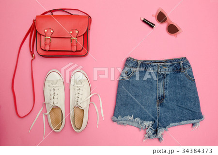 Denim shorts, white sneakers, red handbag Denim shorts, white sneakers, red handbag 34384373