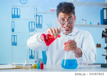 Funny mad chemist working in a laboratory Funny mad chemist working in a laboratory 34387602
