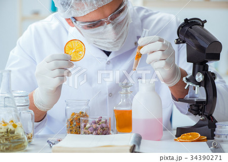 Chemist mixing perfumes in the lab Chemist mixing perfumes in the lab 34390271