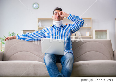 Man freelancer in a cervical collar neck brace Man freelancer in a cervical collar neck brace 34391794