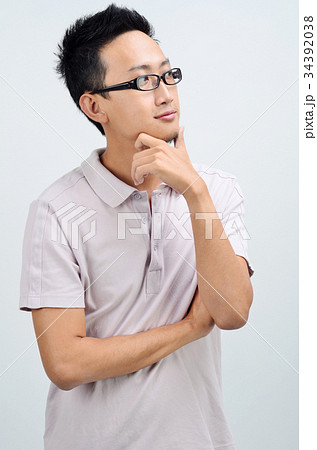 Portrait of casual Asian man thinking Portrait of casual Asian man thinking 34392038