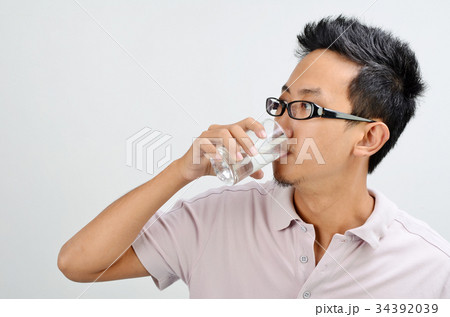 Asian man drinking water Asian man drinking water 34392039