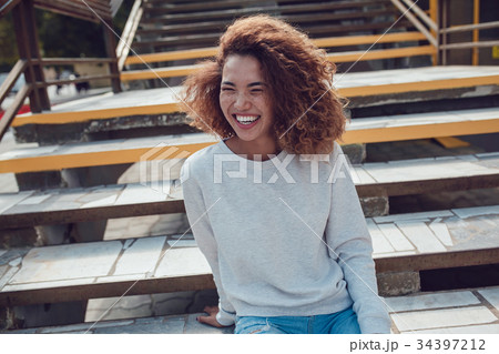 Curly haired girl with freckles in blank grey 34397212