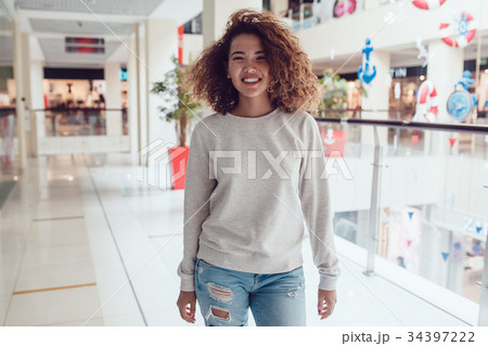 Curly haired girl with freckles in blank grey Curly haired girl with freckles in blank grey 34397222