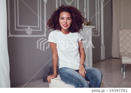 Curly haired girl with freckles in blank white t 34397261