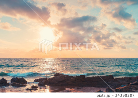 Dramatic sunset over beach 34398287