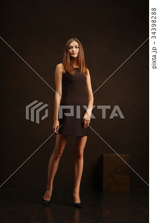 girl in short dress posing near wall girl in short dress posing near wall 34398288