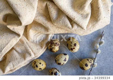Quail eggs and willow branch with beige cloth 34399334