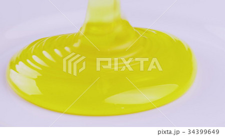 Pour fresh pure honey into a plate. Healthy eating Pour fresh pure honey into a plate. Healthy eating 34399649