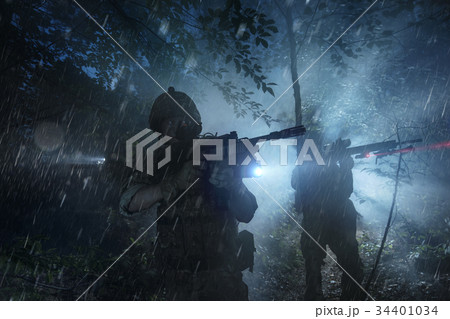 Special Forces soldiers in action. Elite squad moves through fog and smoke. 34401034