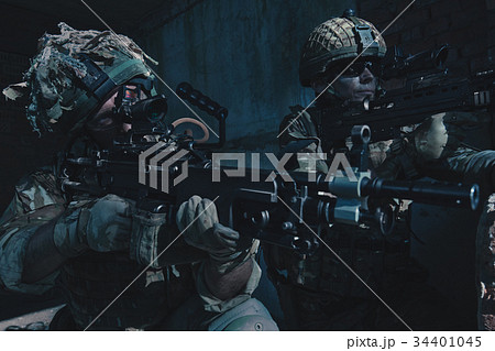 Special Forces soldiers in action. A soldier is preparing to make a shot 34401045